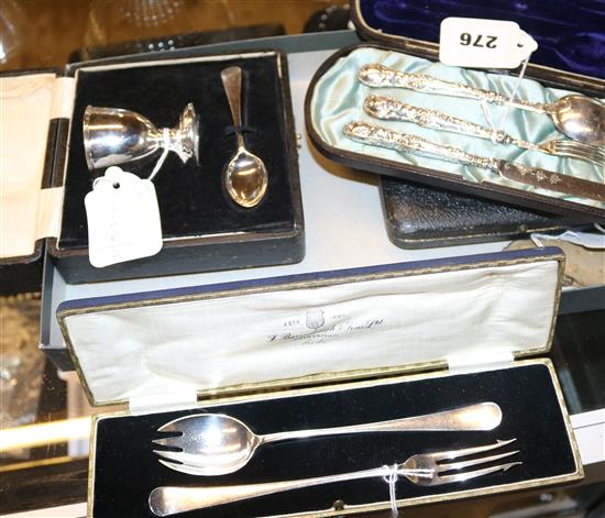 Silver egg cup and spoon, a Christening set, two other cased sets & a pair of small fruit eaters in a pouch